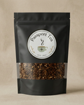 Black tea packaging with 'Passport Tea' label on a beige background