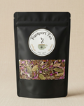 Black tea packaging with 'Passport Tea' label and visible tea leaves on a beige background