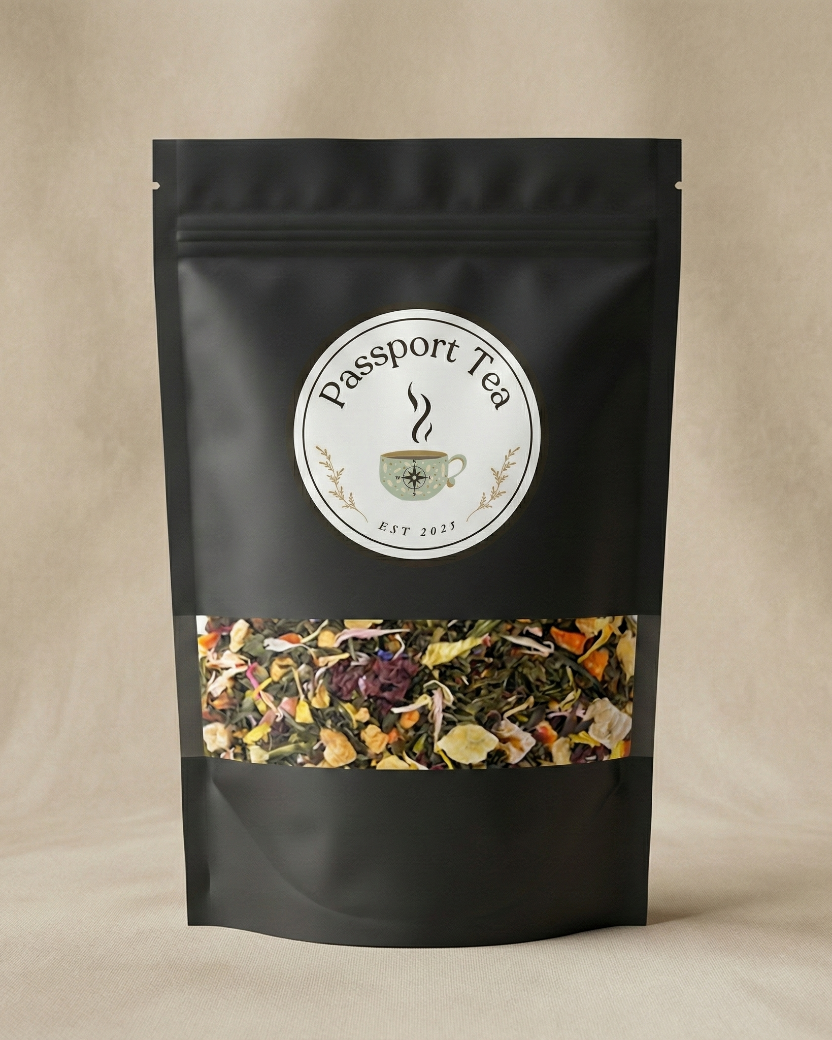 Black tea packaging with 'Passport Tea' label on a beige background