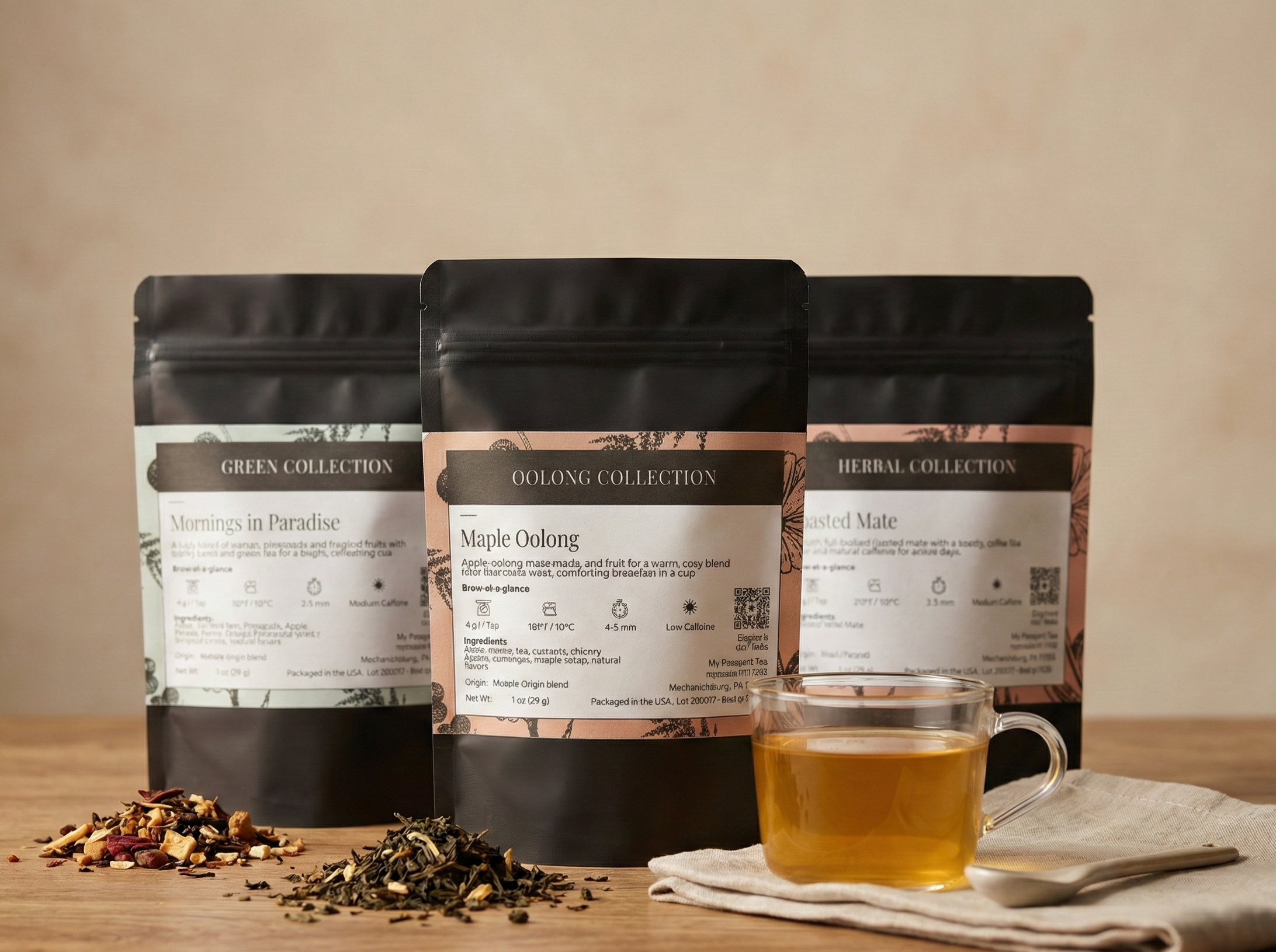 Three black tea bags with labels on a wooden surface next to a cup of tea.