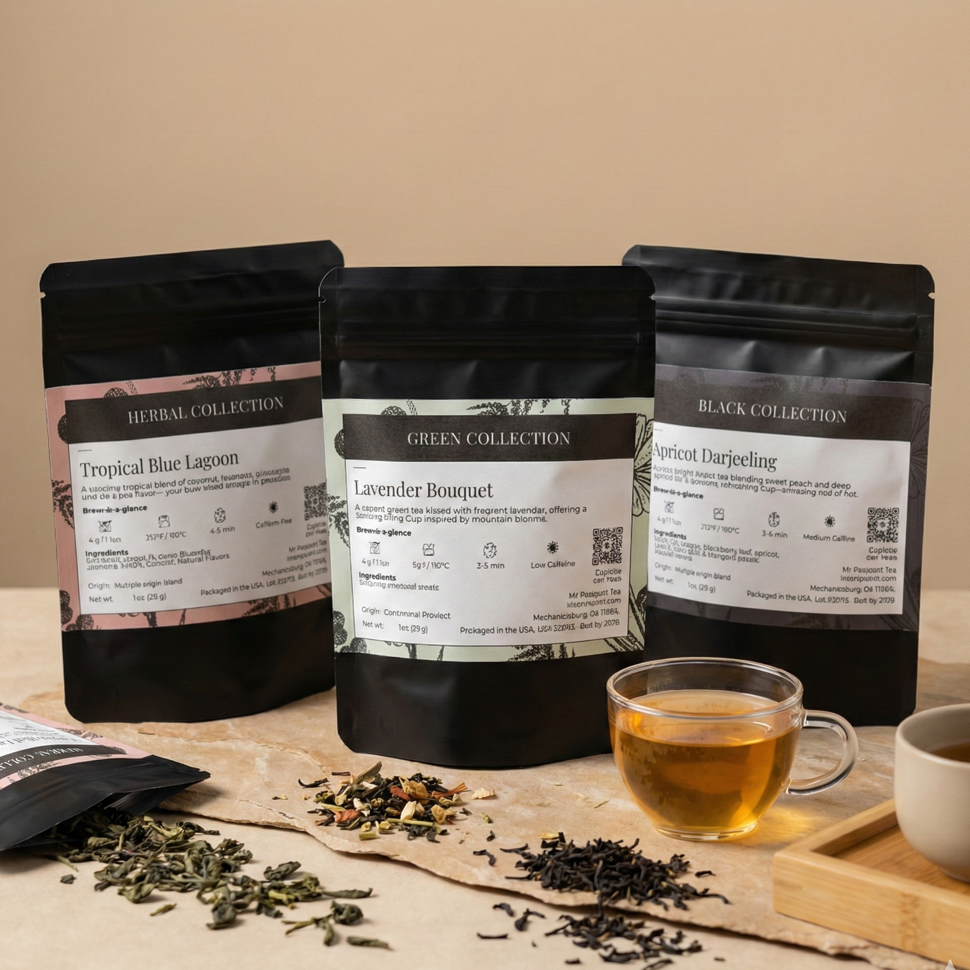 Three black tea bags from different collections on a table with loose tea leaves and a cup of tea.